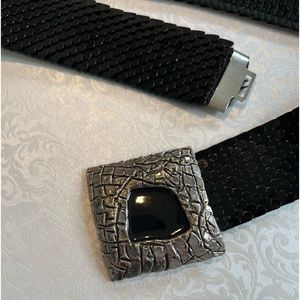 Black stretchy belt with silver buckle.